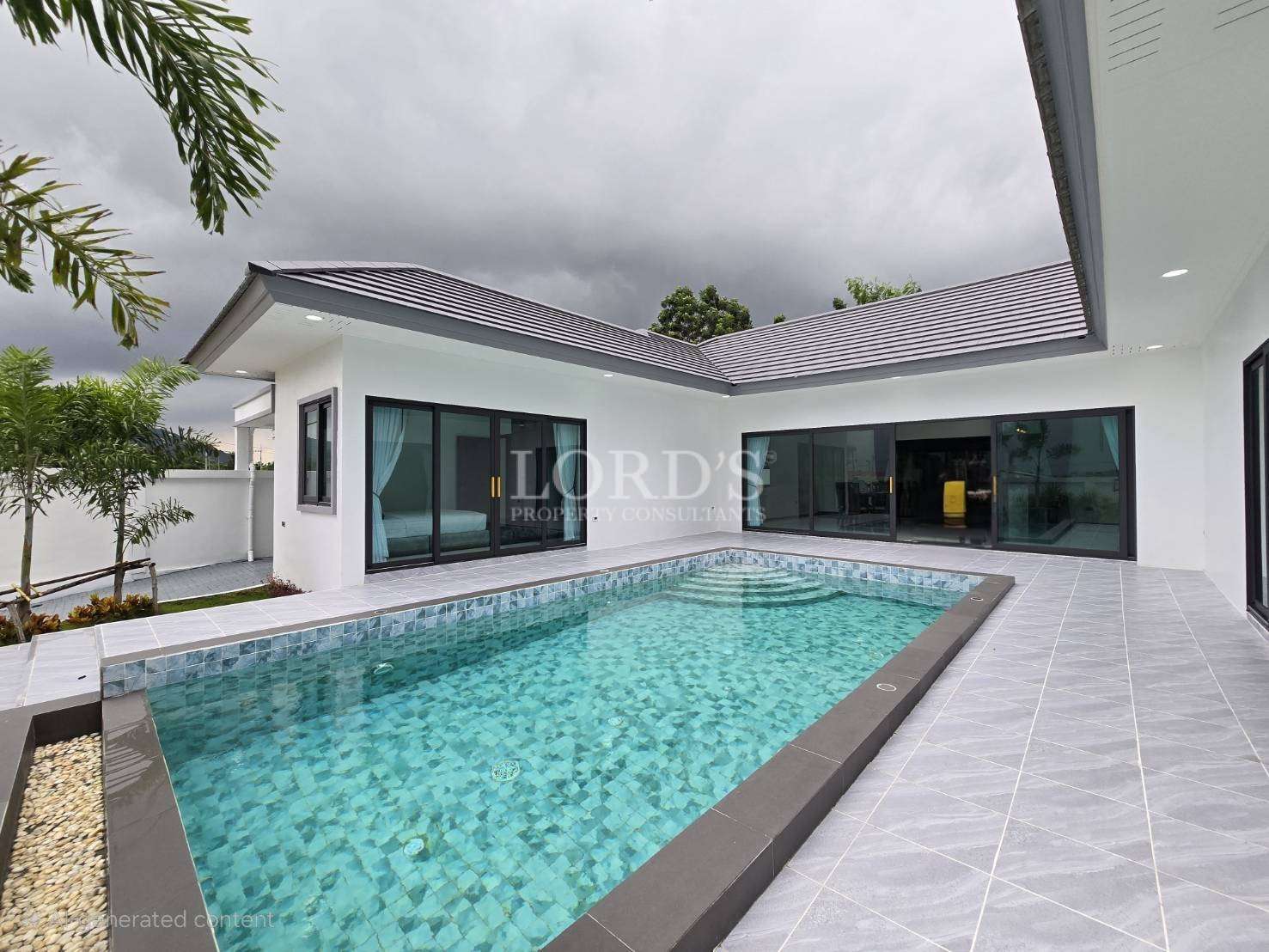 Poolside with tiled deck and villa