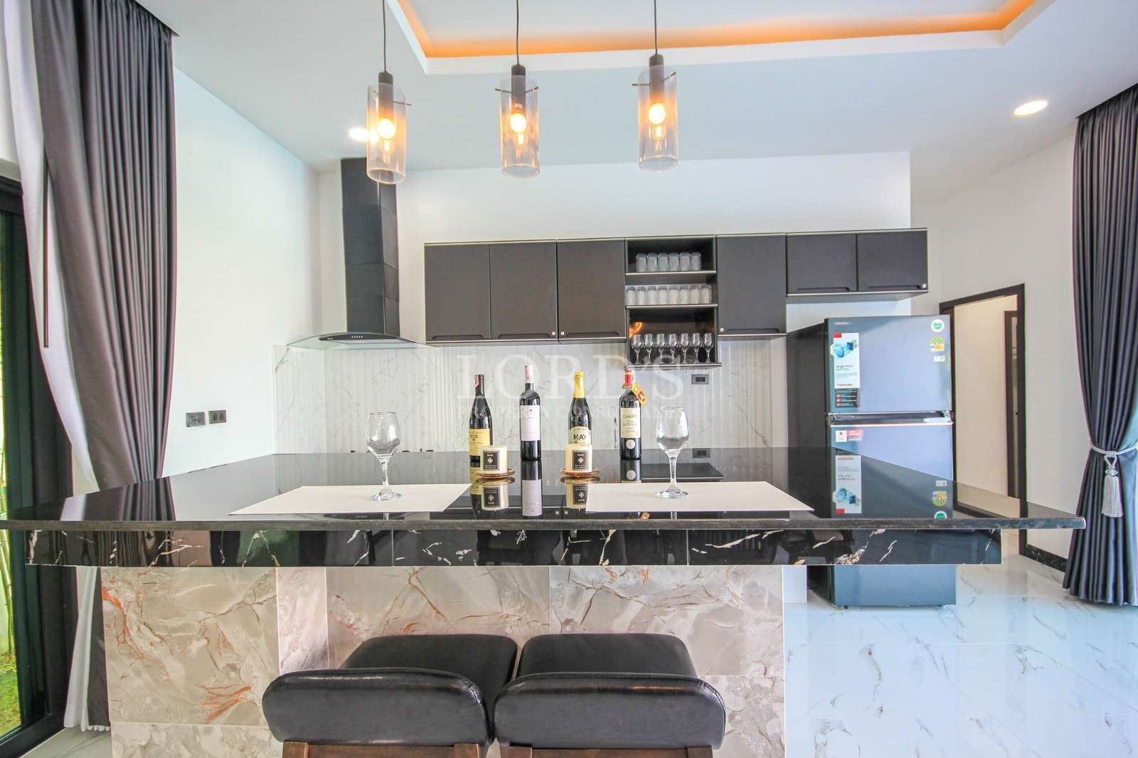 Kitchen with bar stools and lighting
