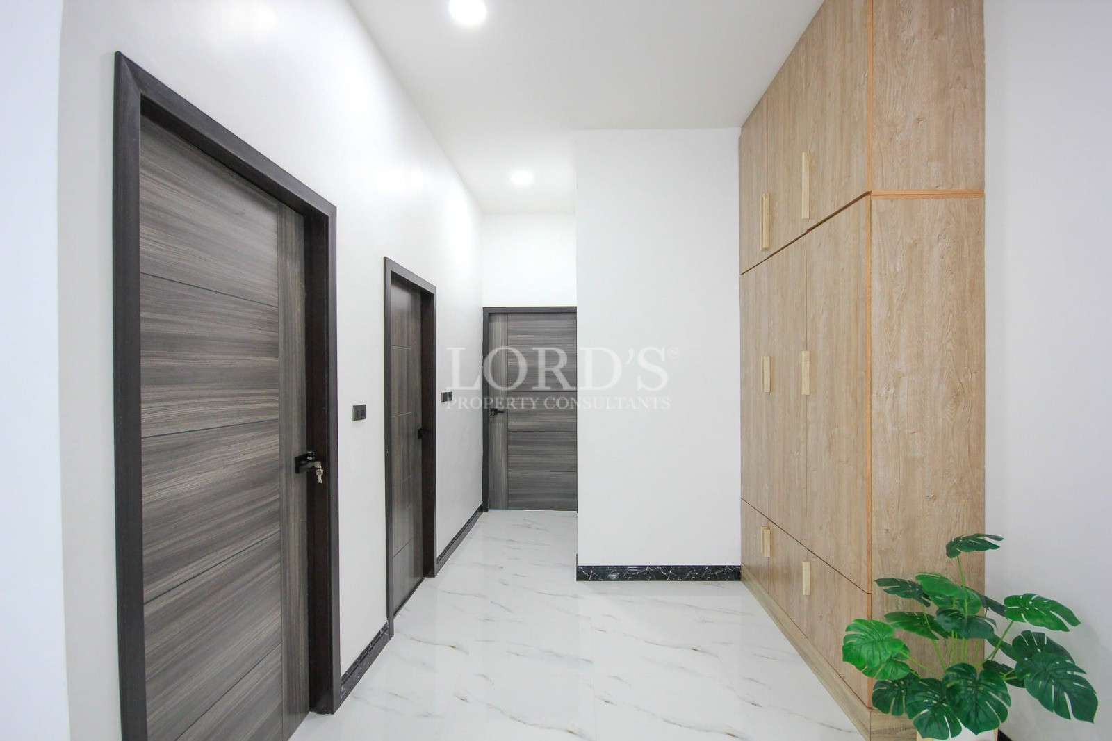 Hallway with doors and wooden wall panels
