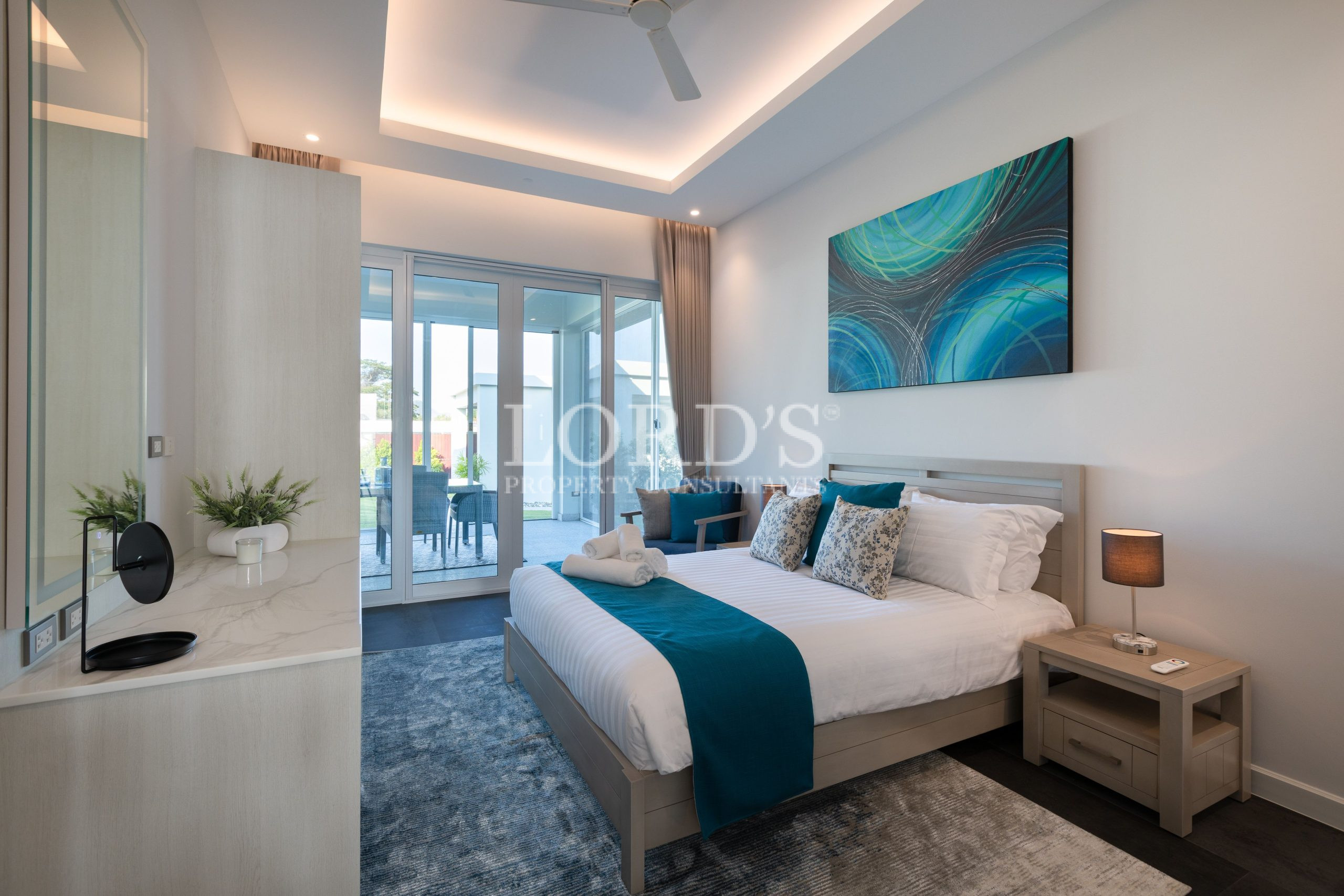 Bedroom with blue bedding and city view