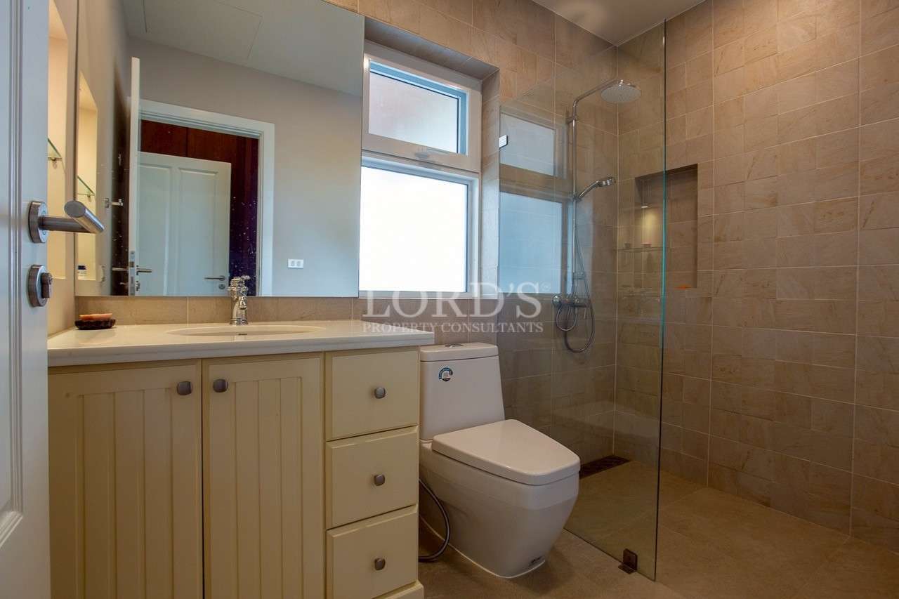 Modern bathroom with glass walk-in shower and vanity cabinet