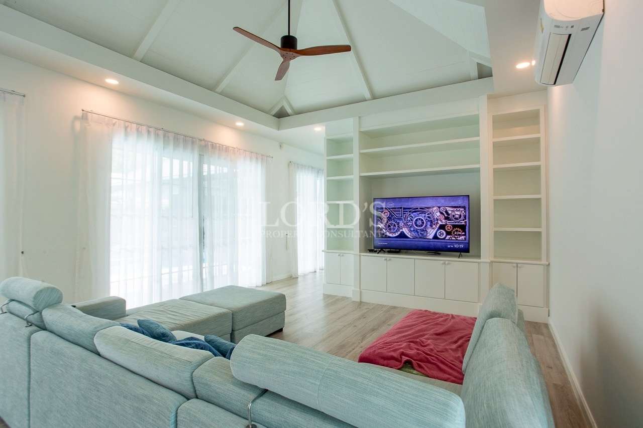 Bright modern living room with sectional sofa and built-in TV cabinet