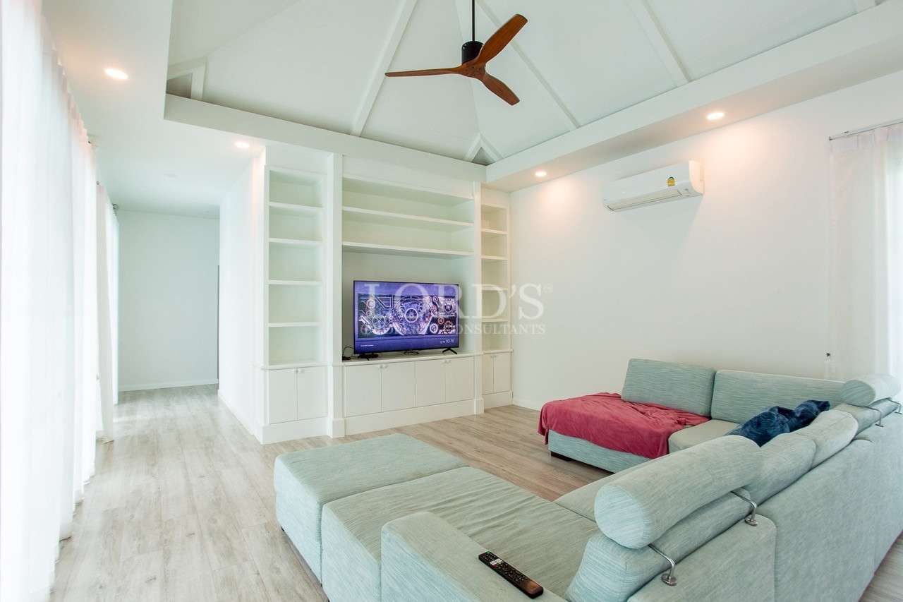 Modern living room with built-in TV unit and sectional sofa