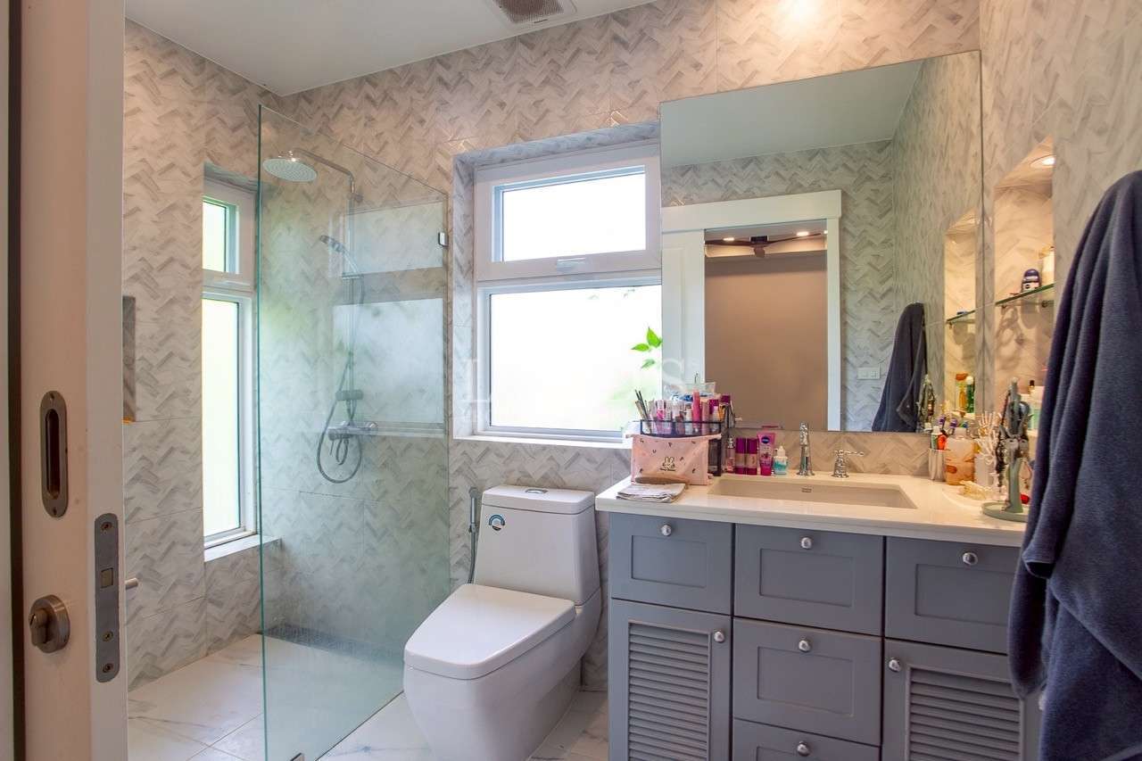 Modern bathroom with glass shower enclosure and single vanity sink