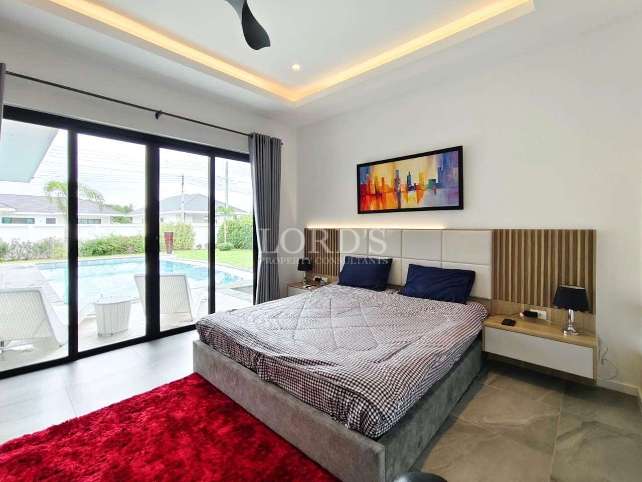 Bedroom with bed and red rug