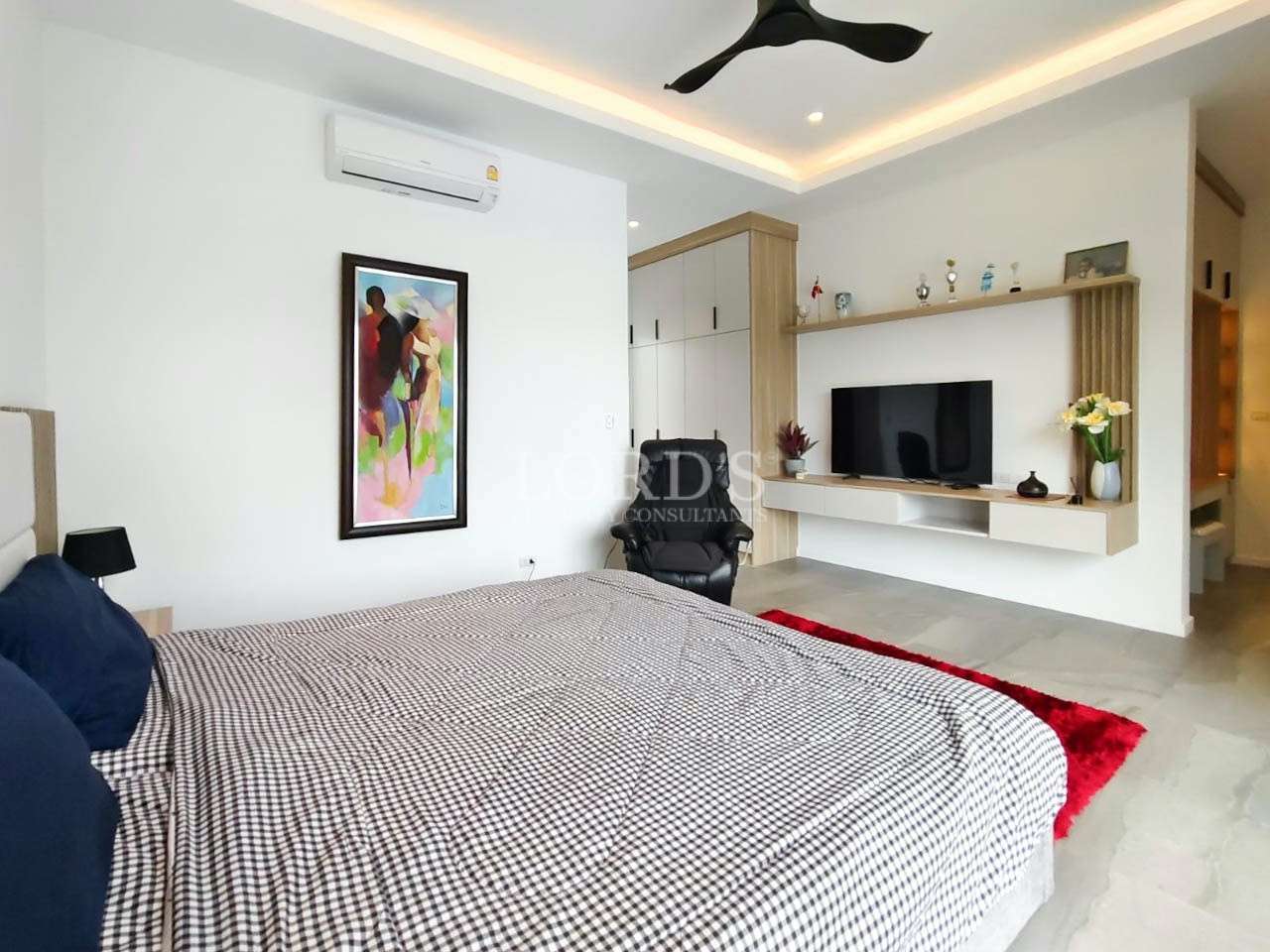 Bedroom with bed and wall artwork