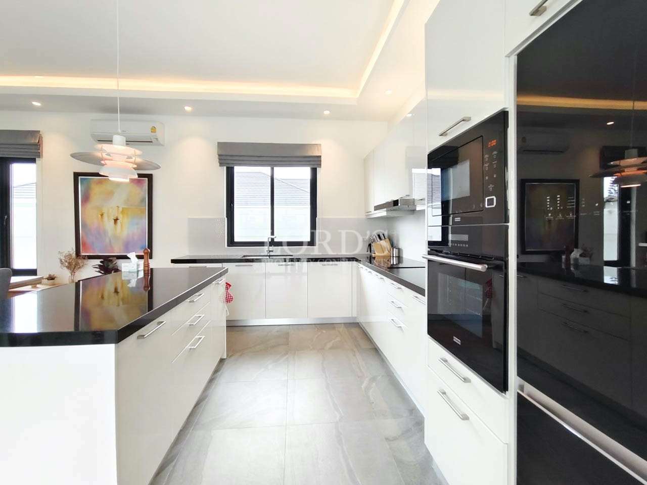 Kitchen with white cabinets and window light