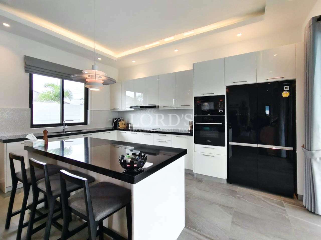 Kitchen with cooktop and black appliances