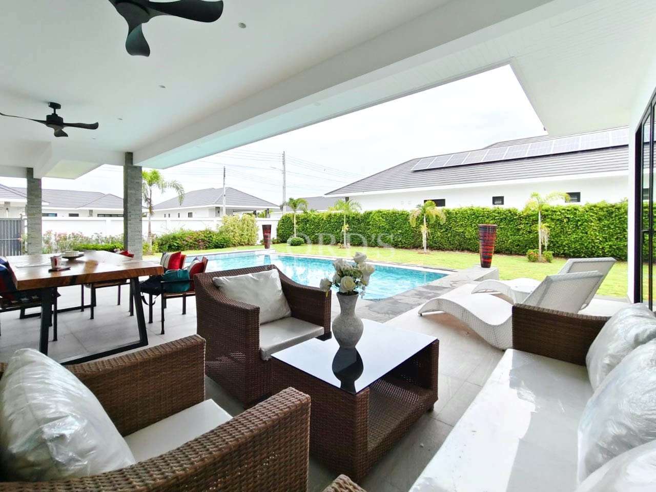 Outdoor lounge with sofa and pool view