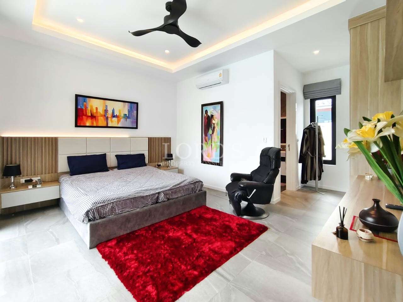 Bedroom with bed and red rug
