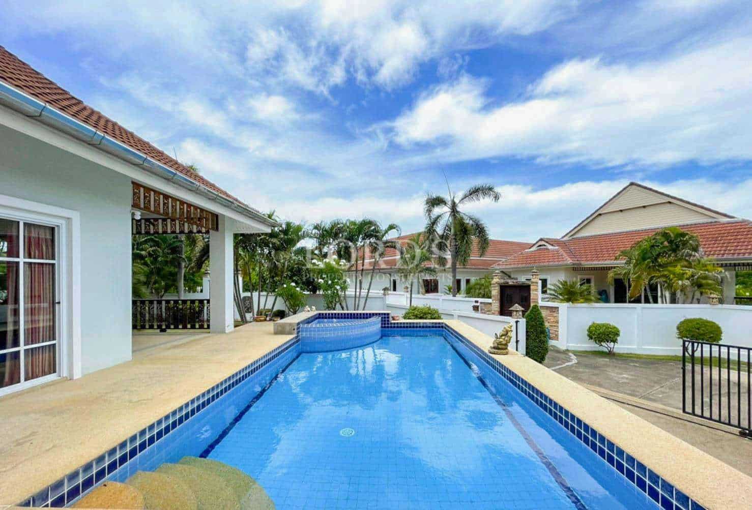 Long swimming pool with garden view