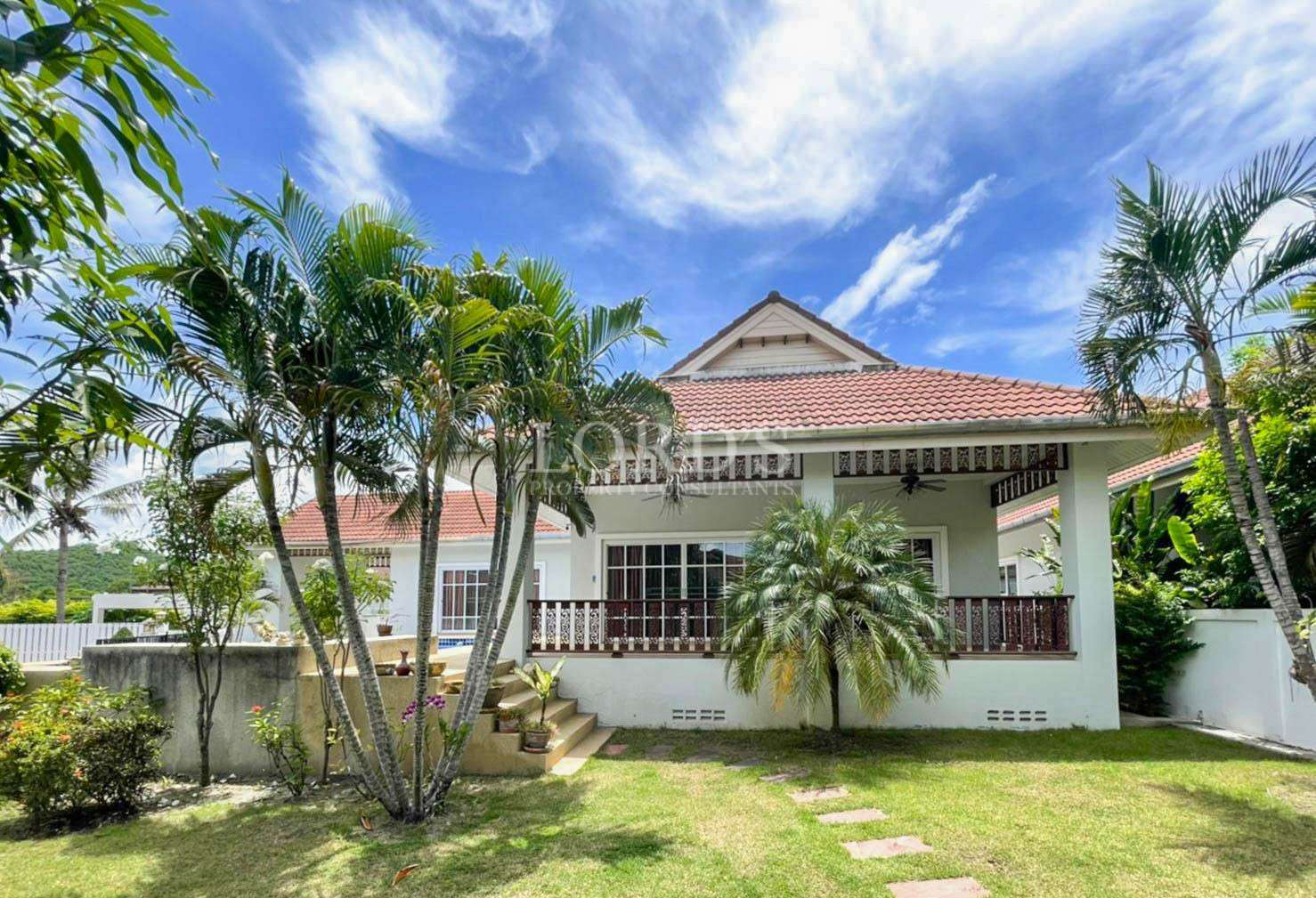 Villa exterior with lawn and plants