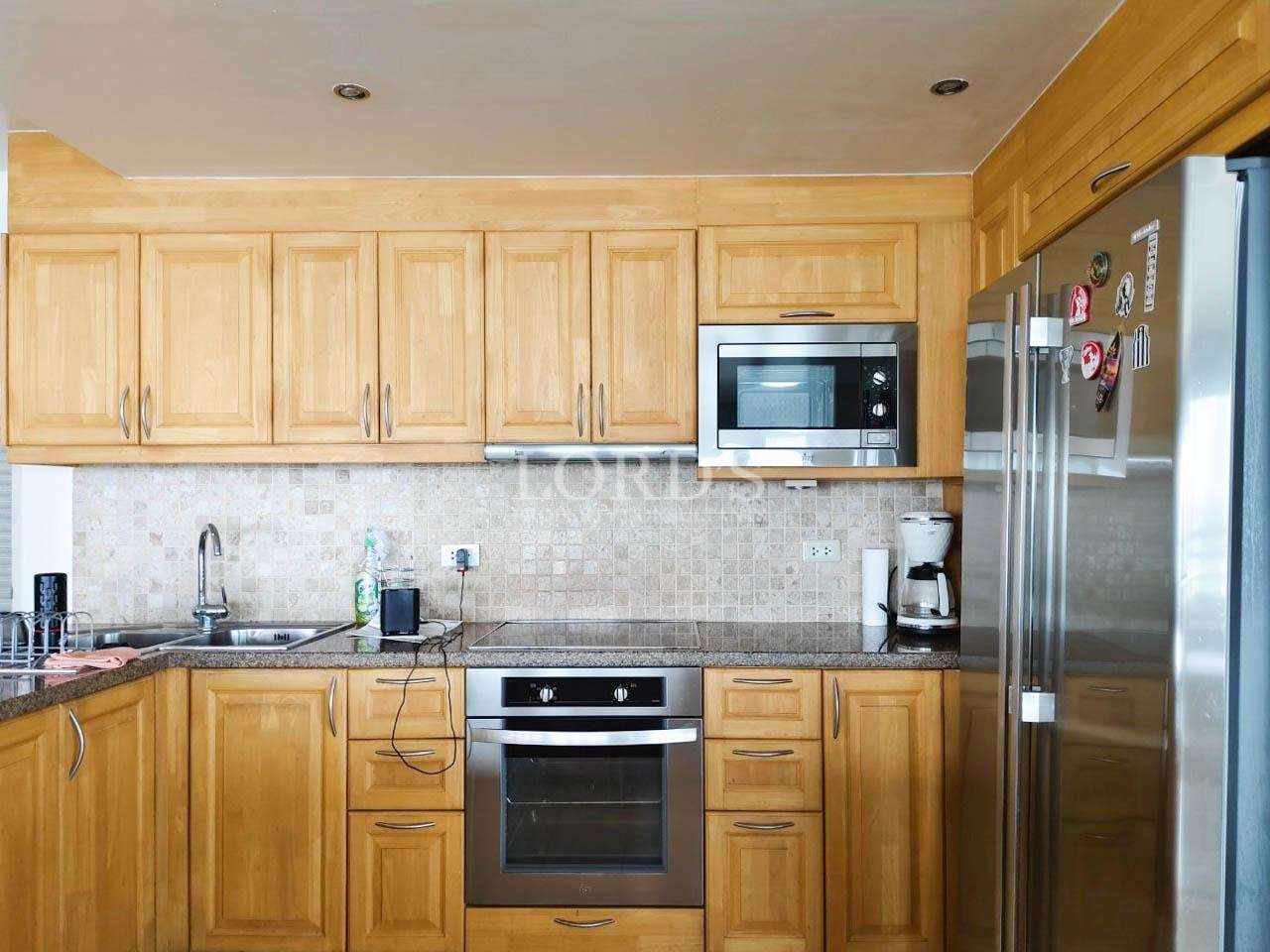 Kitchen with wooden cabinets and appliances