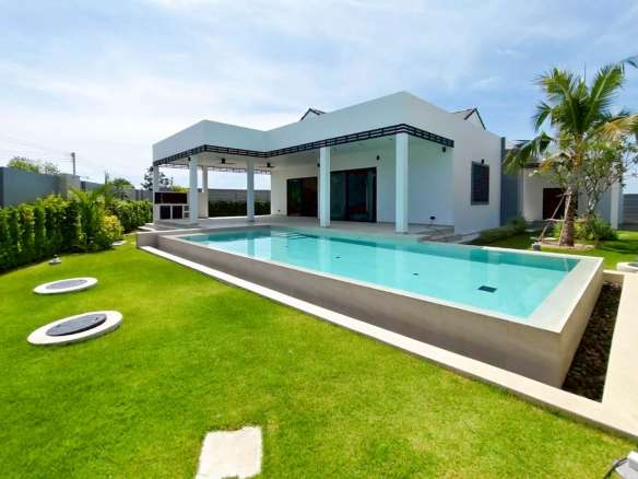 Modern villa with private swimming pool, landscaped garden, and covered terrace.