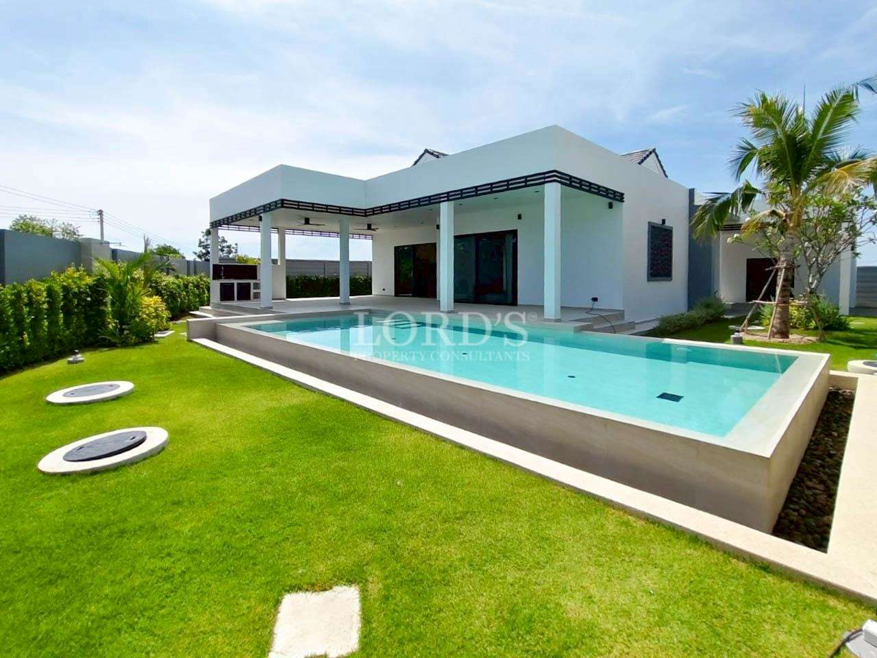 Modern villa with private swimming pool, landscaped garden, and covered terrace.