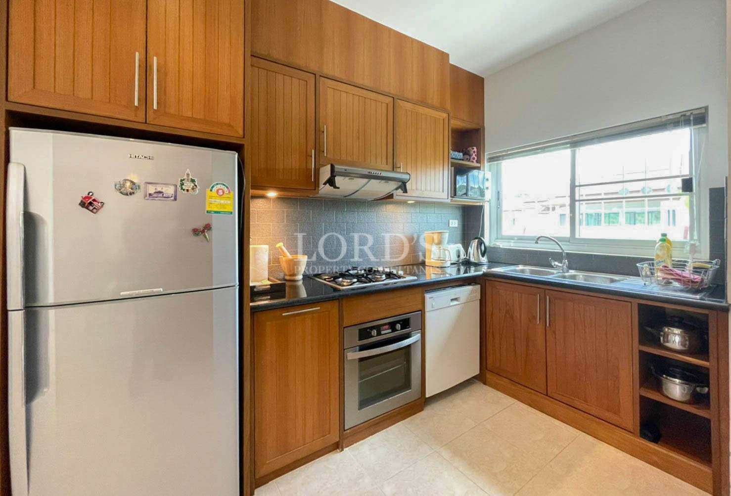 Kitchen with cabinets and refrigerator