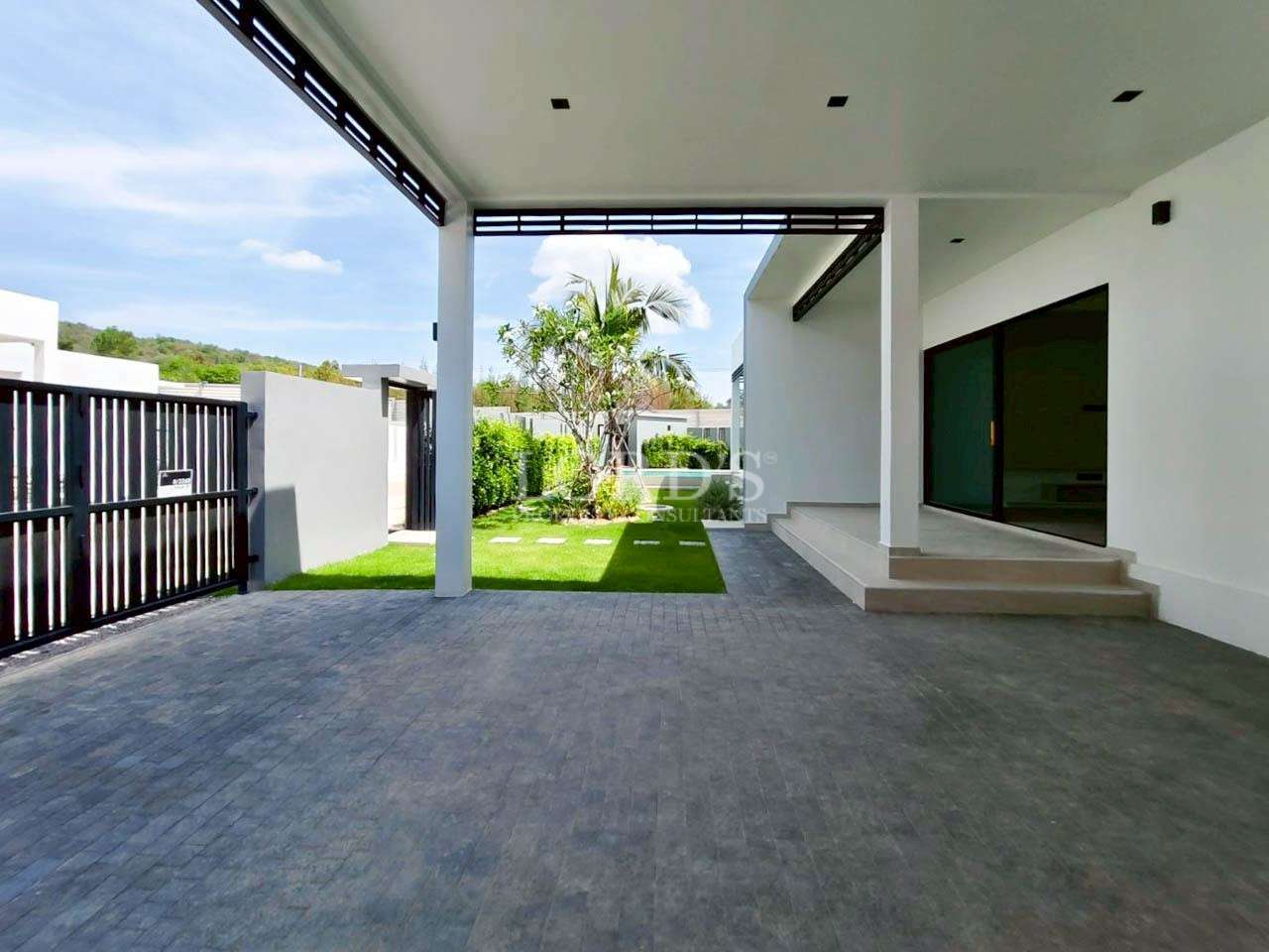 Modern house carport and front yard with covered patio, sliding glass doors, and landscaped garden.
