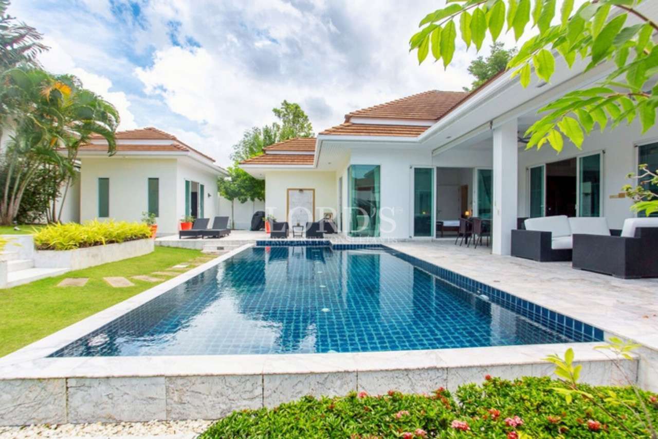 Modern villa with pool and greenery