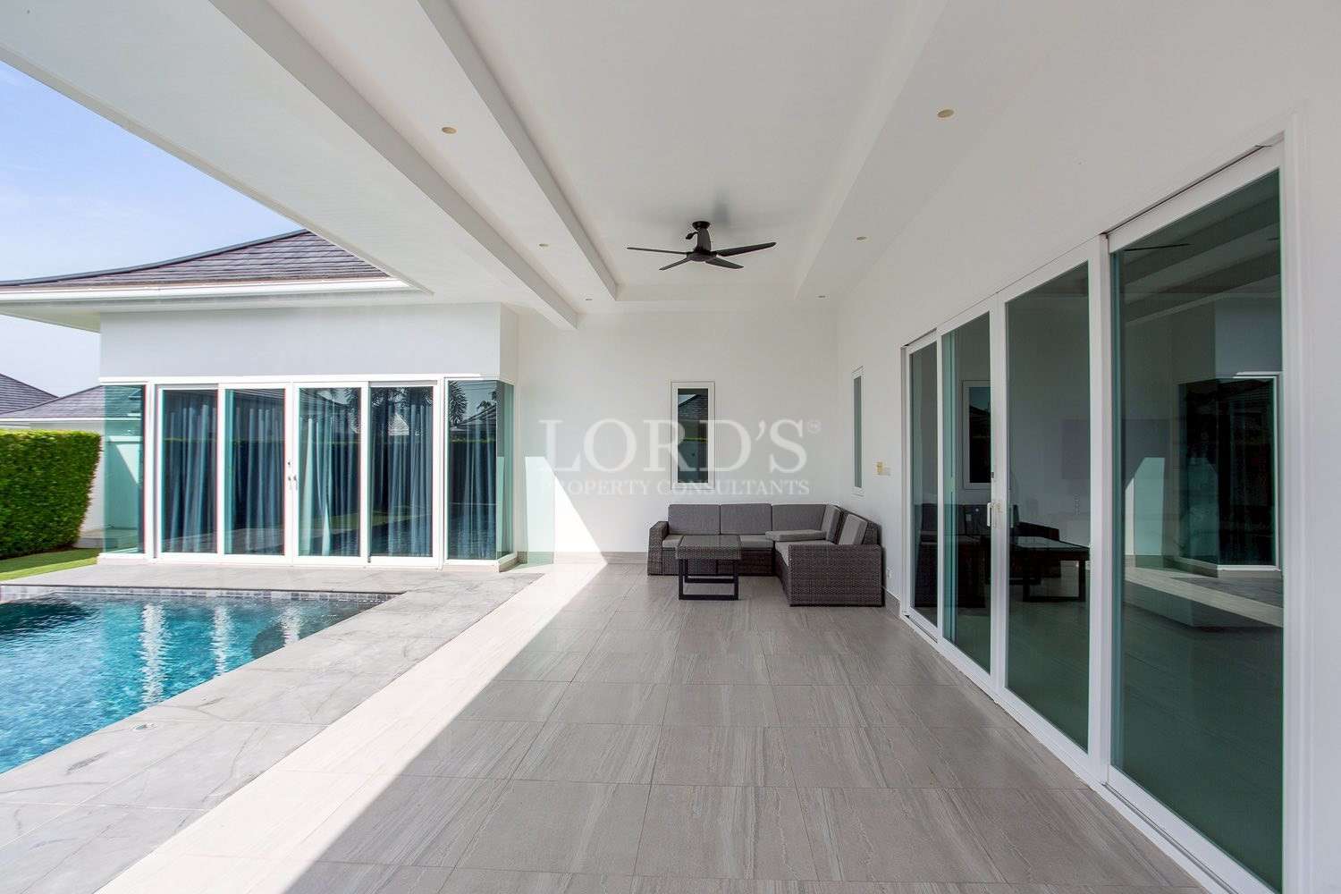 Outdoor terrace with seating and pool view