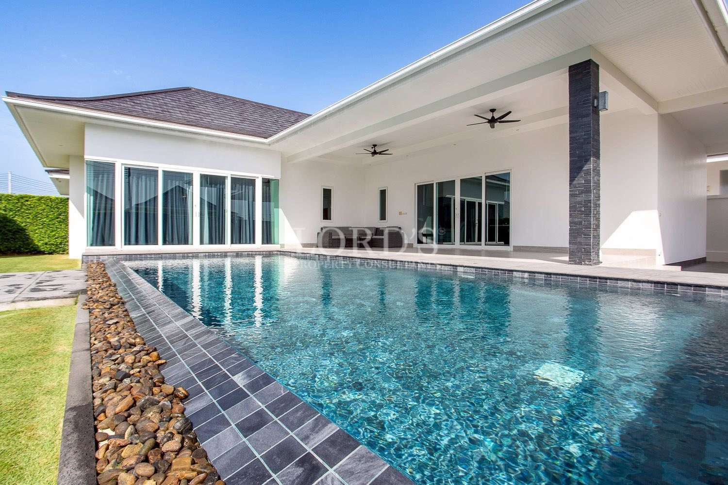 Pool with villa and blue water