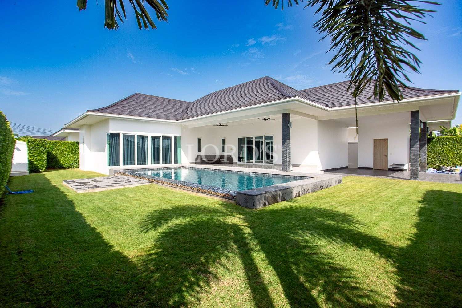 Villa exterior with lawn and garden