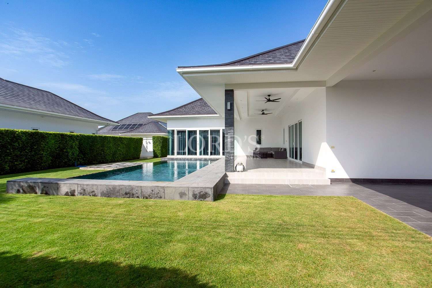 Villa exterior with lawn and pathway