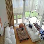 Living room with large windows and sofa seating