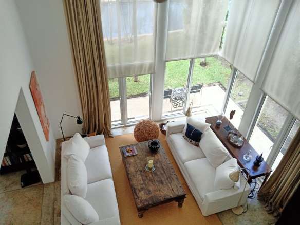 Living room with large windows and sofa seating