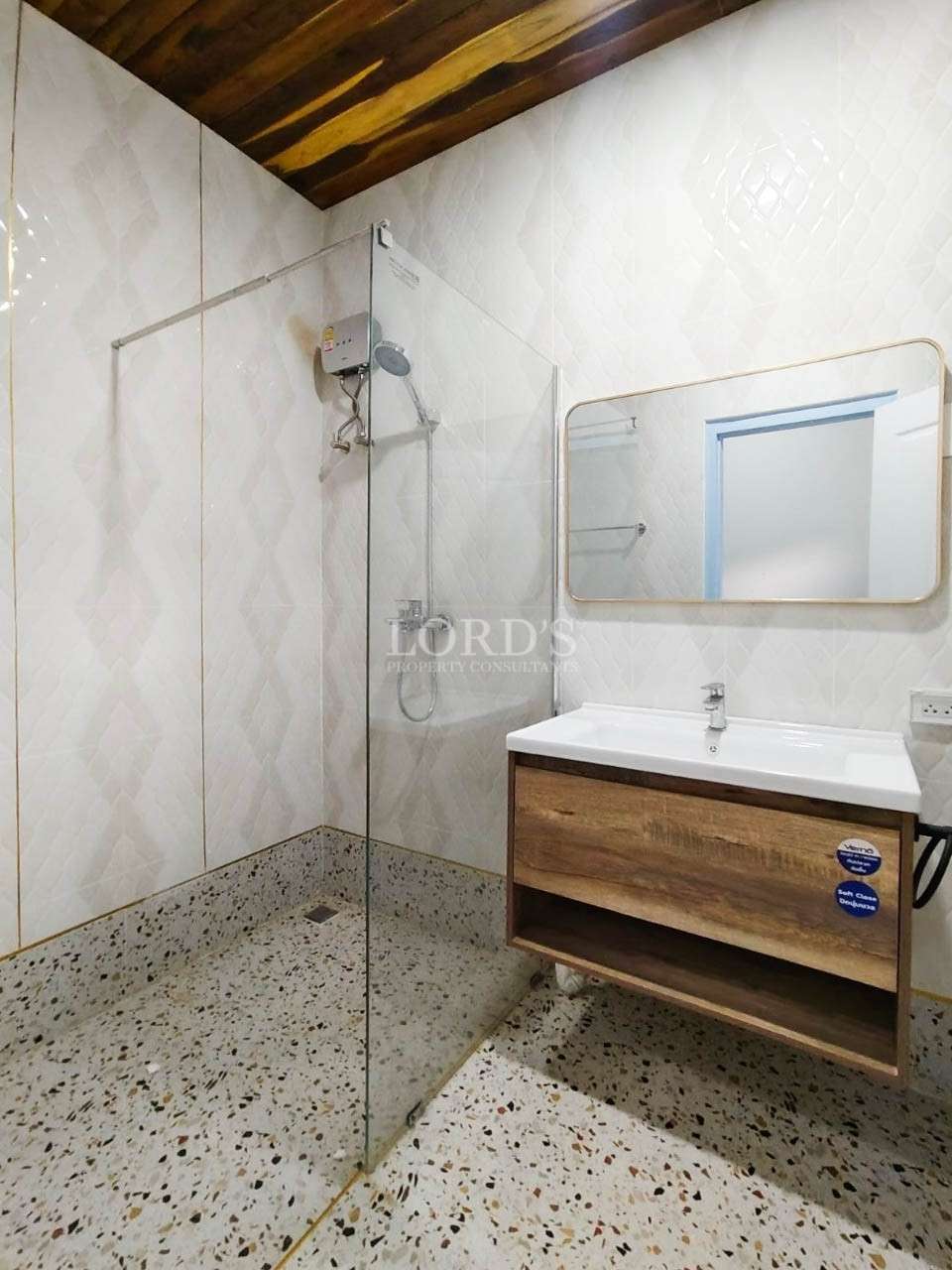 Bathroom with sink and tiled walls