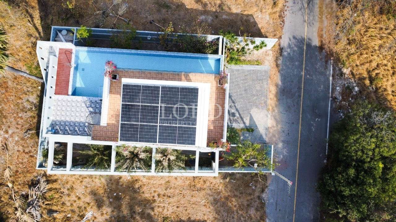 Aerial view of house rooftop with solar panels