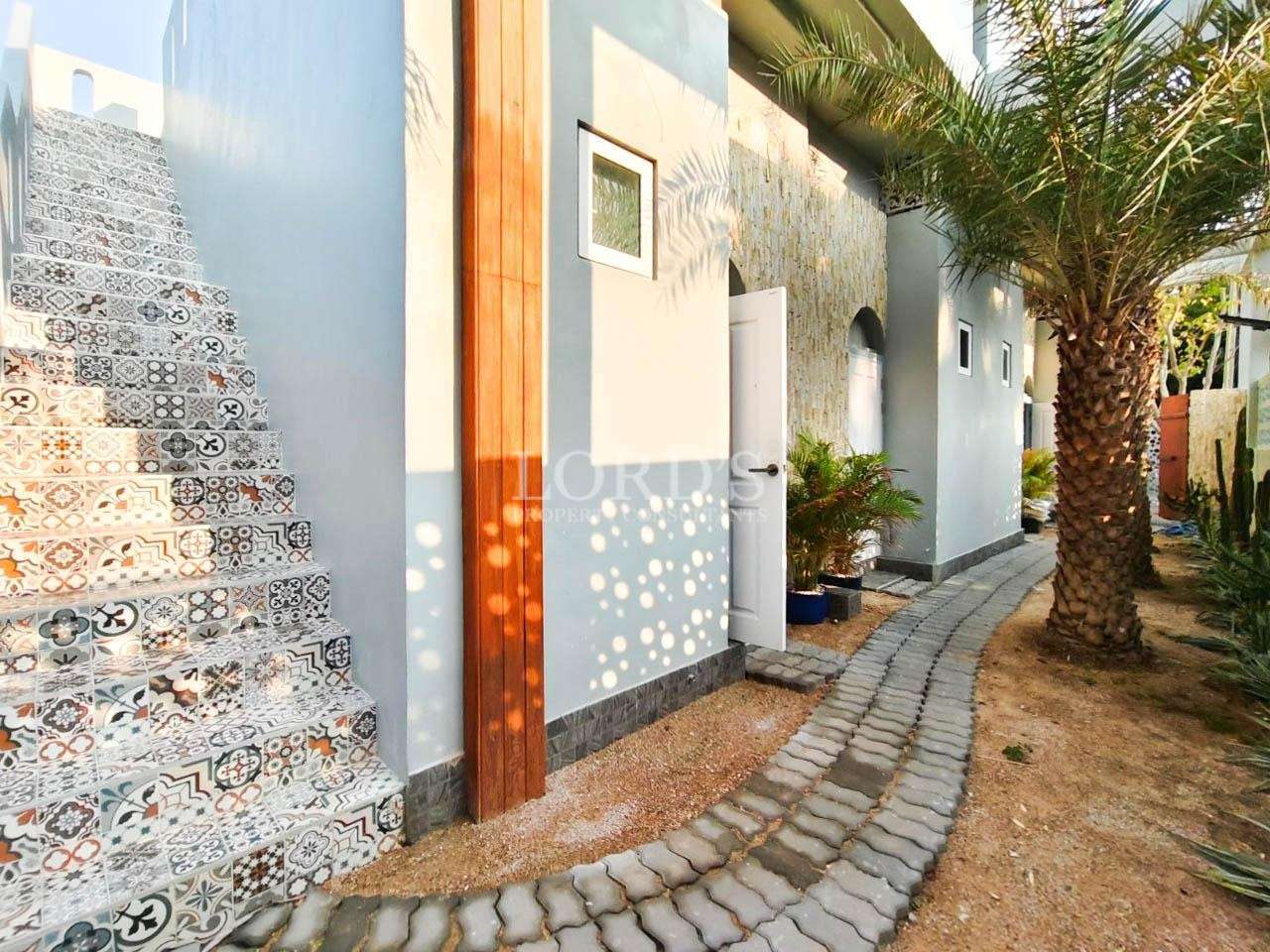 Villa exterior walkway with decorative wall tiles