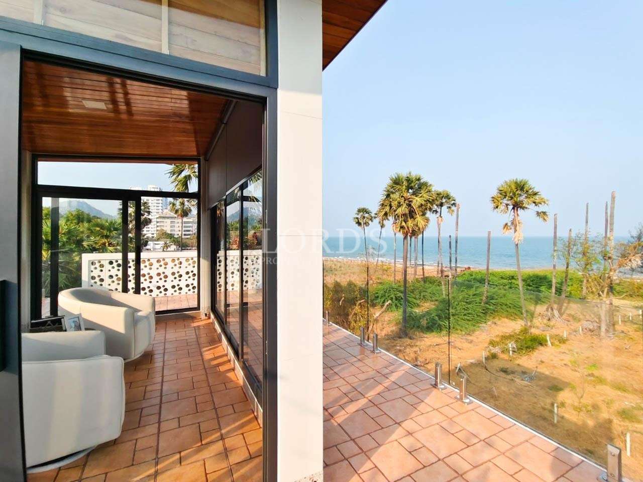 Balcony overlooking palm trees and ocean