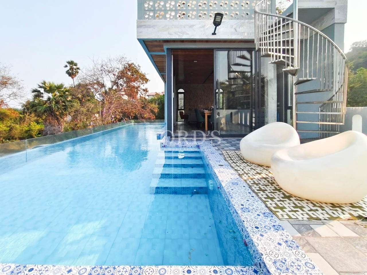 Infinity pool with modern villa view