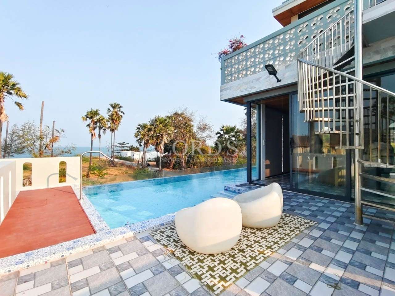 Poolside terrace with seating and view