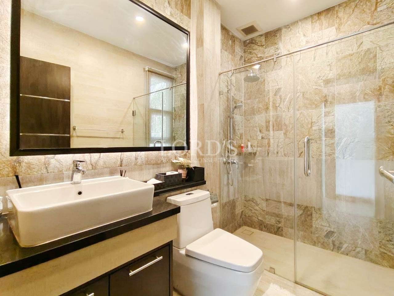 Bathroom with vanity sink and marble wall tiles