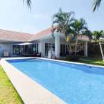 Modern villa exterior with long rectangular pool