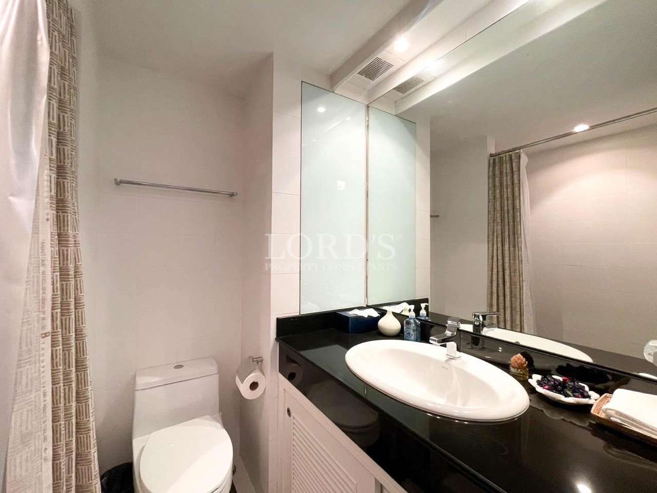 Bathroom with sink and large mirror