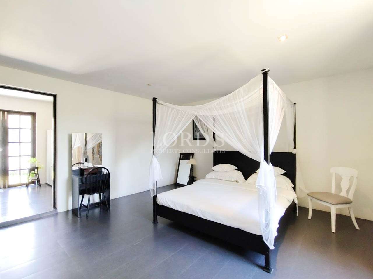 Bedroom with canopy bed and white curtains