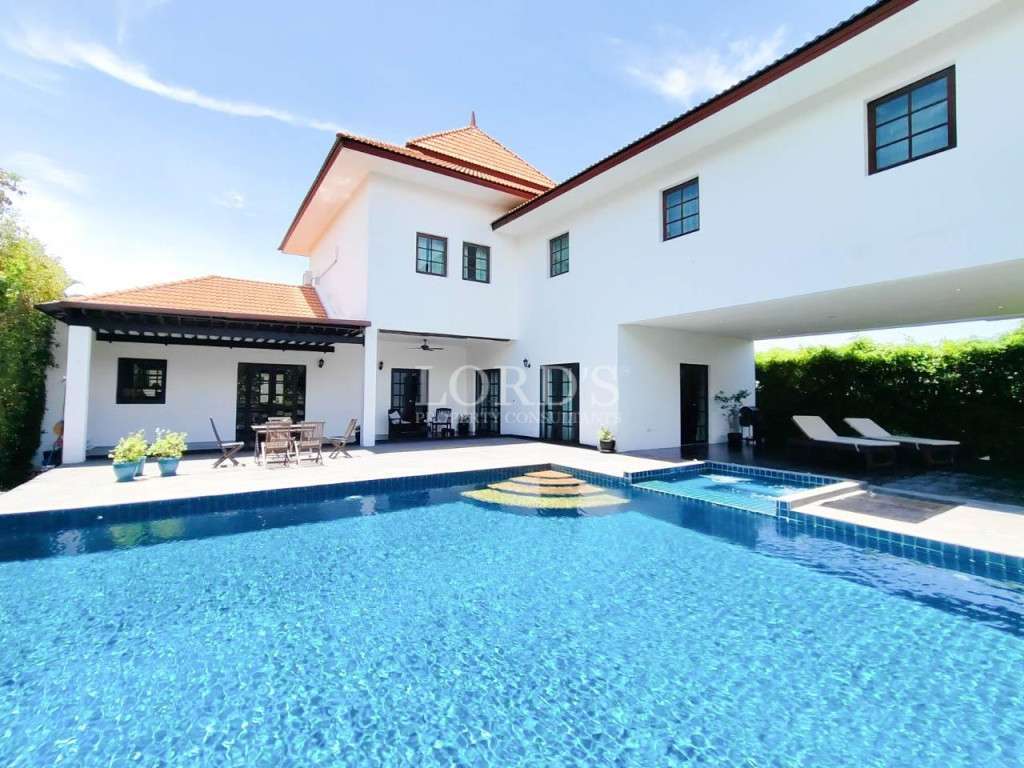 Swimming pool with villa and clear sky