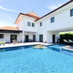 Swimming pool with villa and clear sky