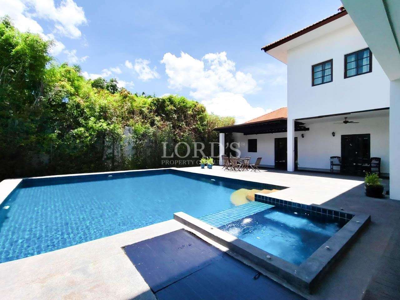 Poolside with villa exterior and deck