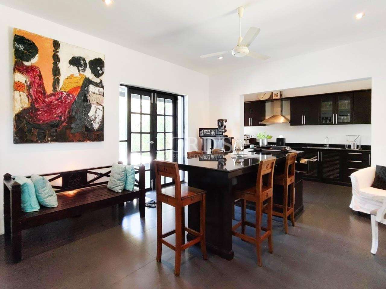 Dining area with wooden table and kitchen