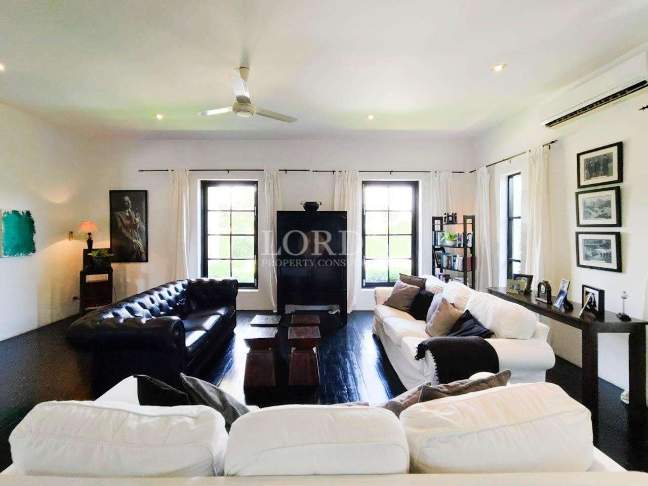 Living room with leather sofa and windows