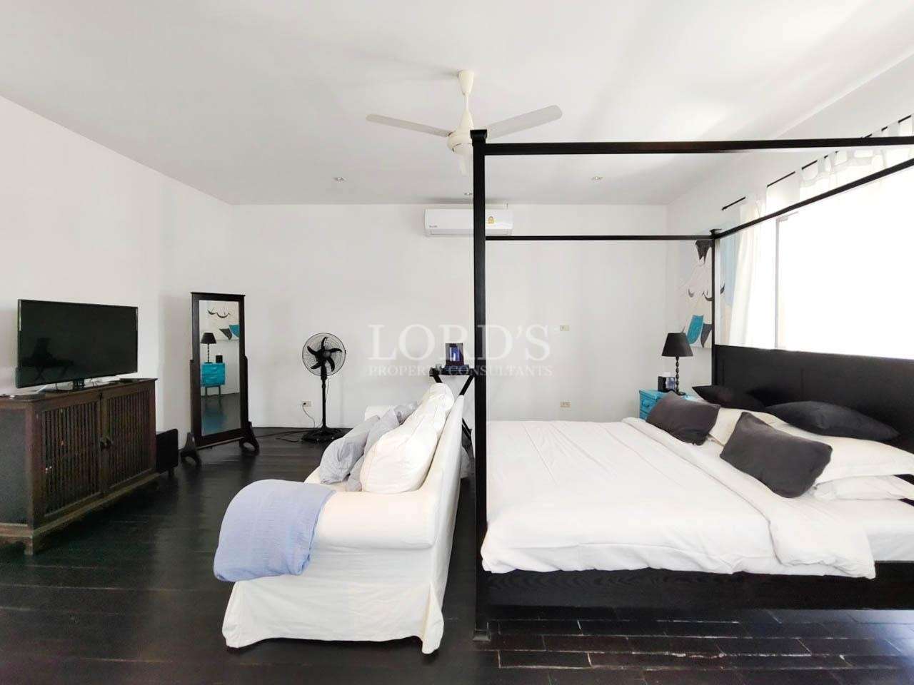 Bedroom with canopy bed and wooden floor