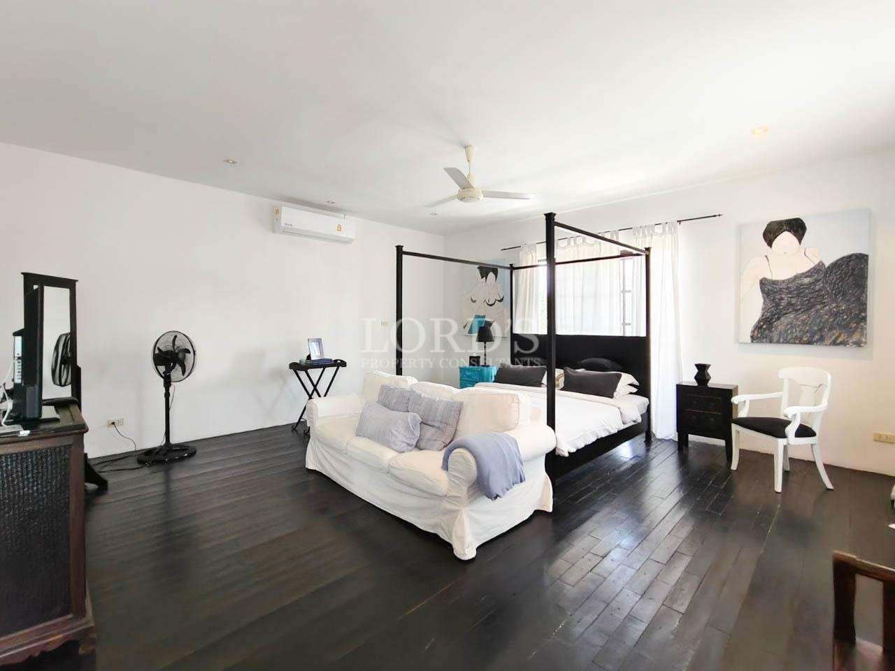 Bedroom with canopy bed and seating area