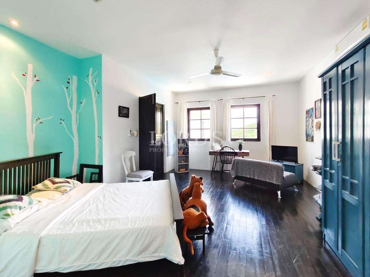 Bedroom with bed and desk near window