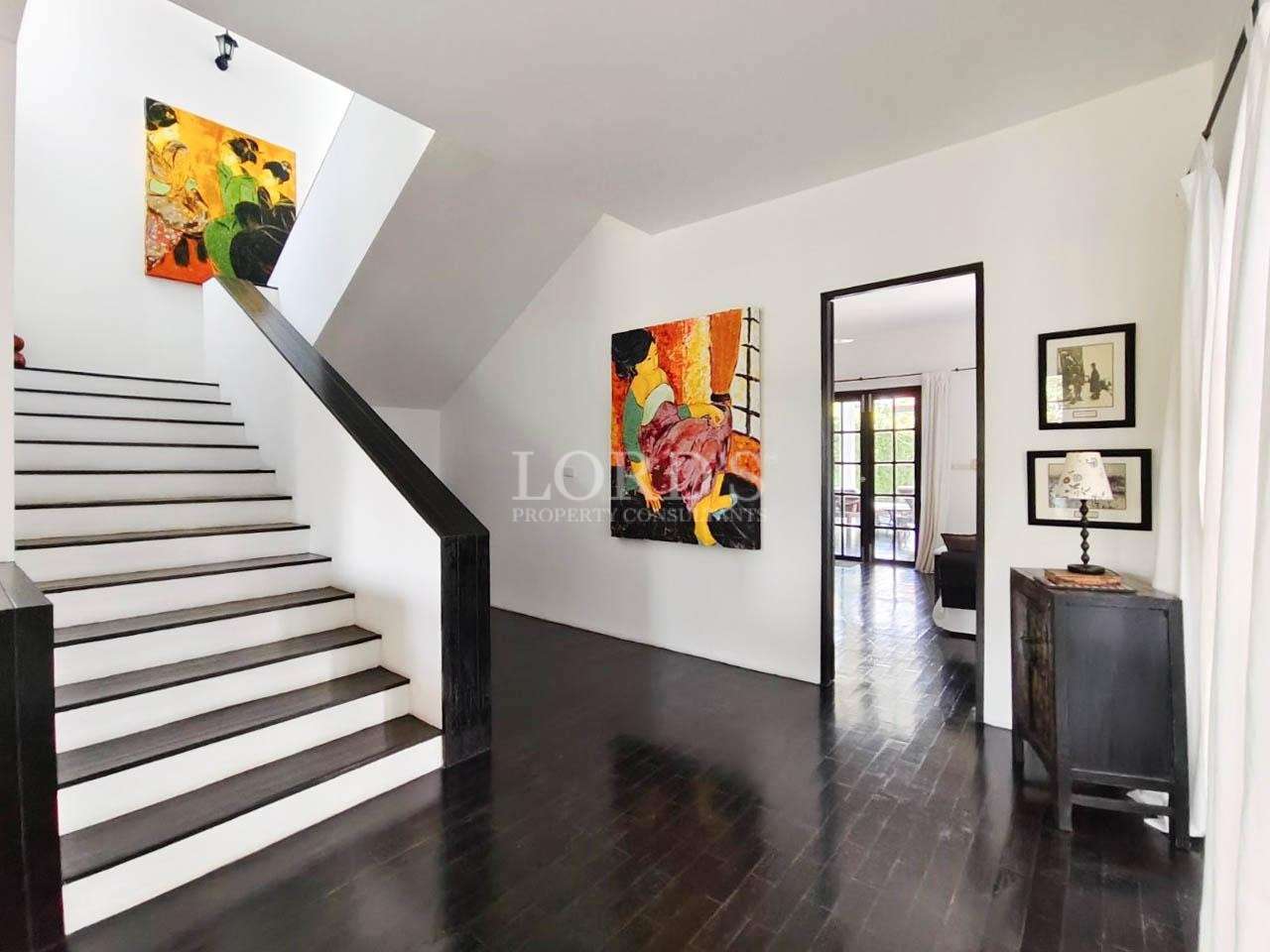 Hallway with stairs and wall decor