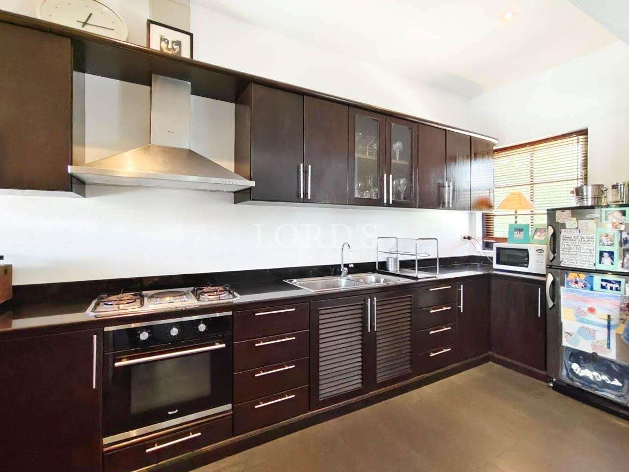 Kitchen with modern appliances and dark cabinets