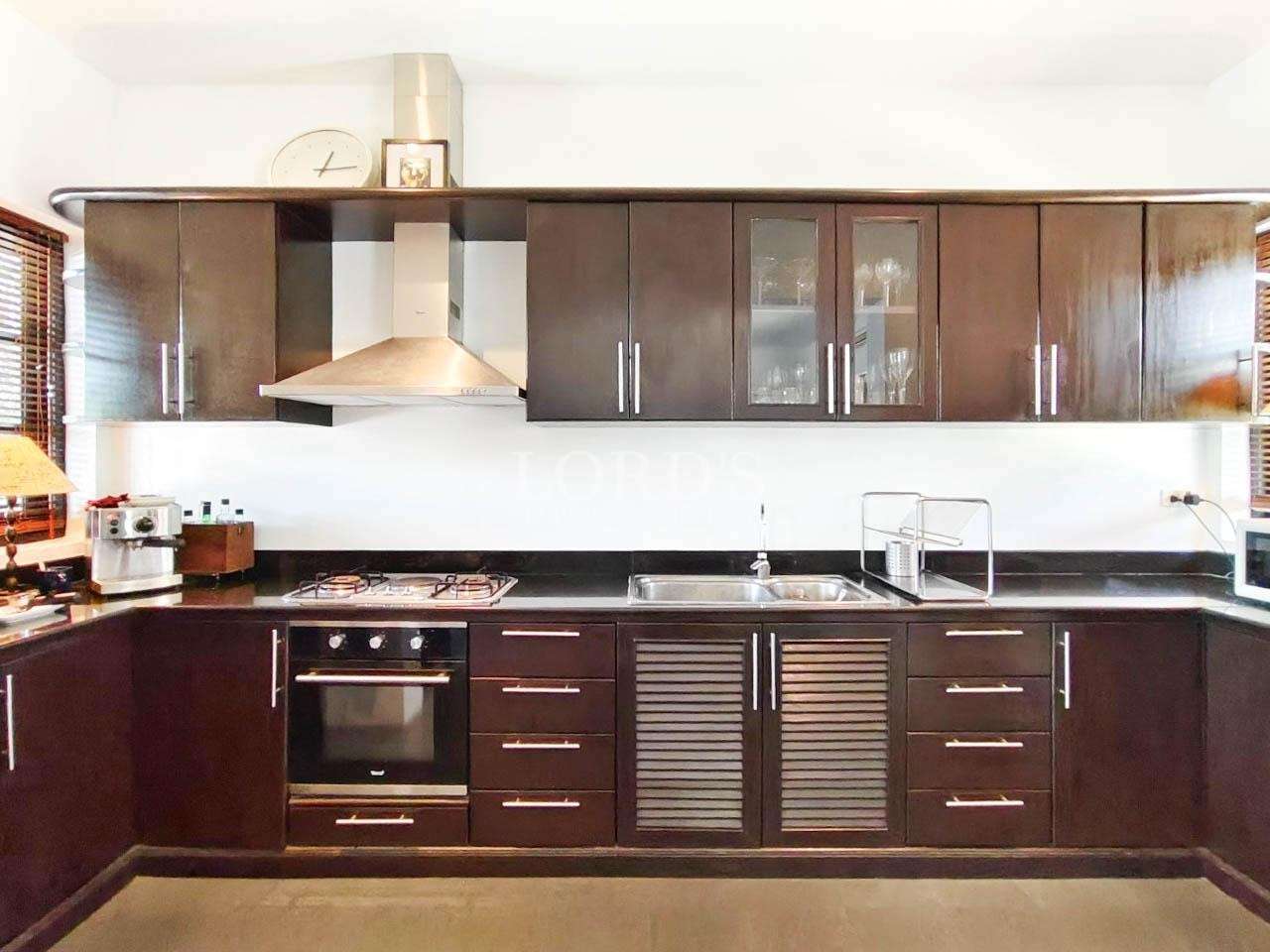 Kitchen with stove and overhead cabinets