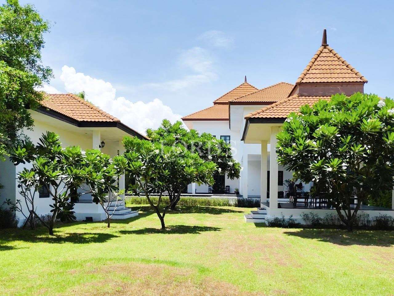 Villa exterior with lawn and trees